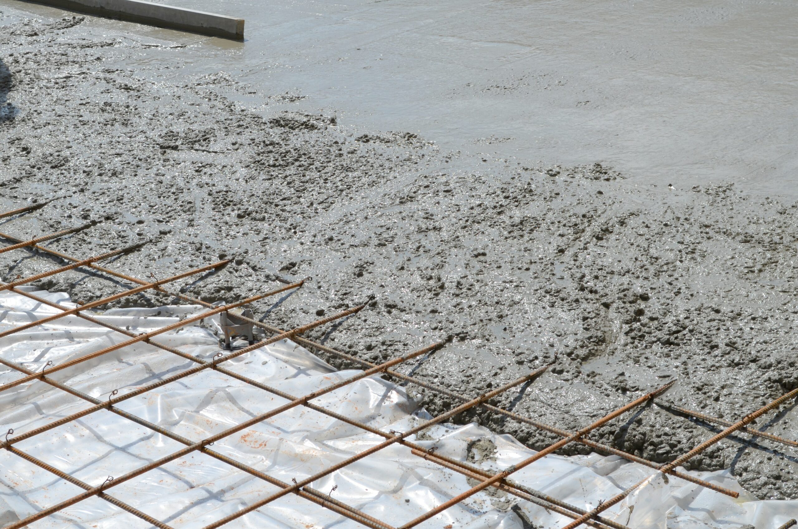 Wet concrete has been poured over steel rebar